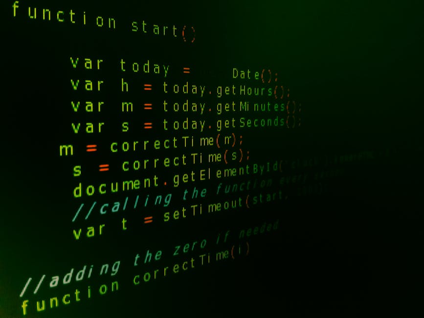 A close-up photograph of a computer screen displaying programming code with brightly colored syntax highlighting in green, orange, yellow, and blue on a dark background. The code appears to be JavaScr